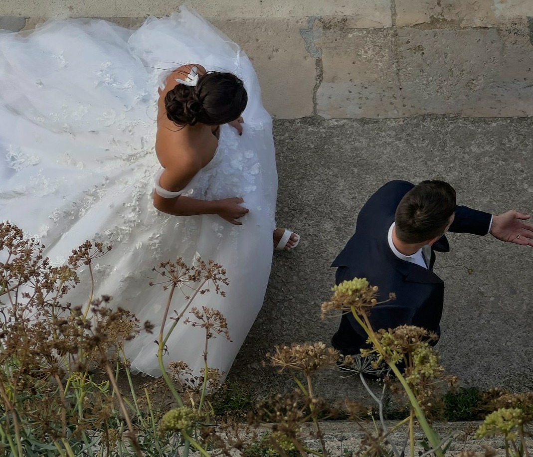 A beautifully edited collage of wedding moments, including the bride getting ready, the first kiss, and a dance scene. The images should flow seamlessly together, showcasing emotional highlights with light flares and elegant transitions between scenes.