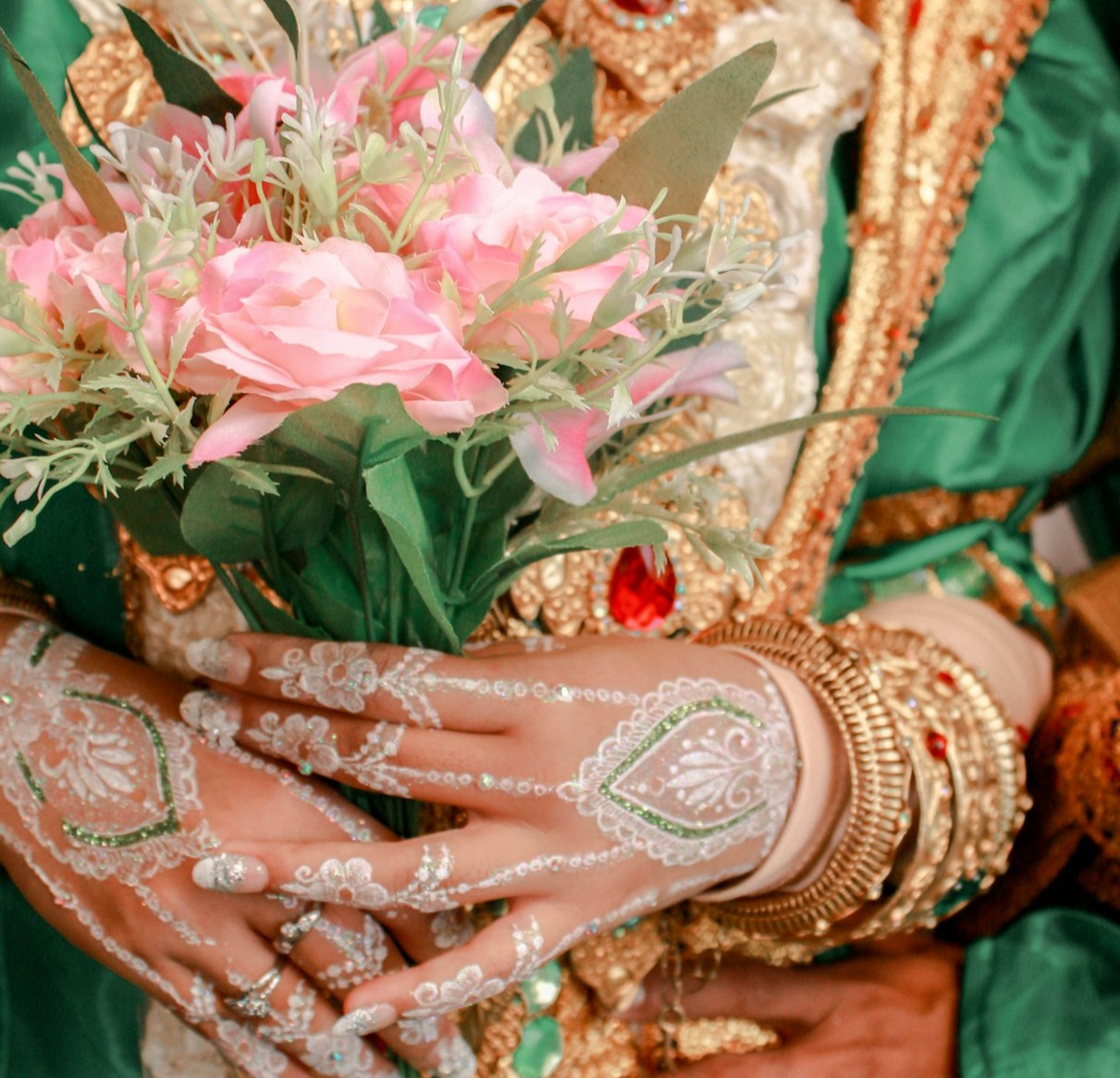 A beautifully arranged wedding scene with a talented photographer capturing a joyful couple. The setting should be decorated elegantly with flowers and soft lighting, depicting an emotional moment during the ceremony. The photographer is focusing intently through a camera lens.