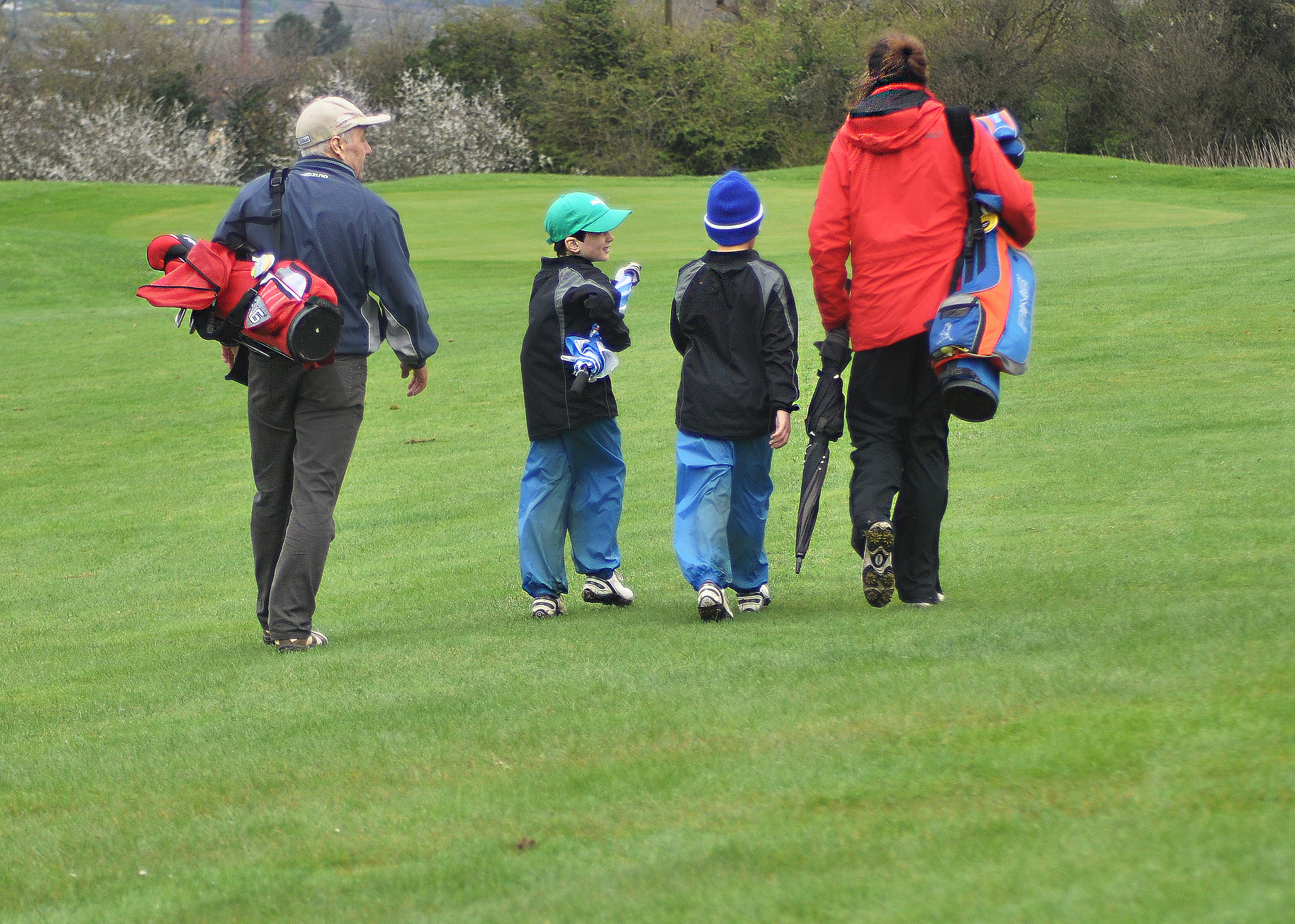 family playing golf in winter