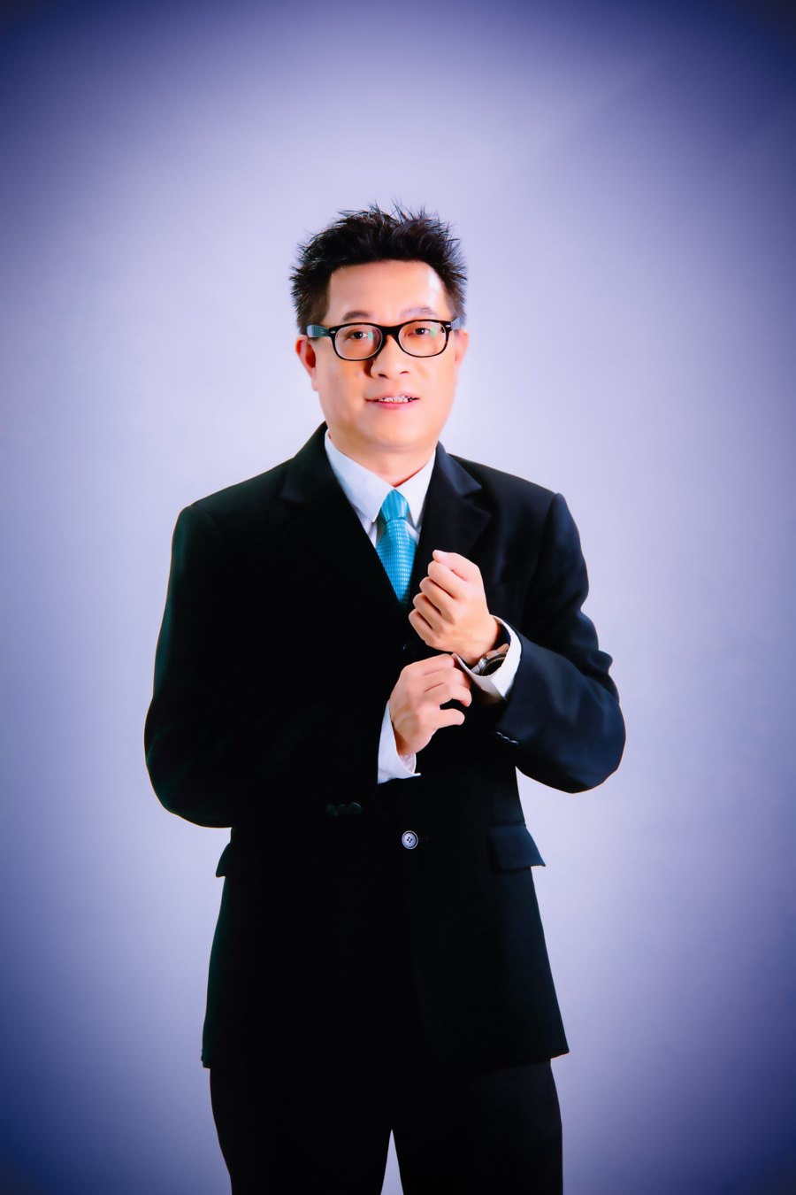 Simon Lee, corporate trainer and credit risk specialist, in a dark suit and teal tie