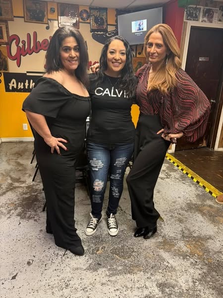 A photorealistic image focusing on a current family member of Gilberts, possibly the owner or chef, working in the kitchen. Include details like their hands expertly preparing food, the warm lighting in the kitchen, and the background featuring traditional Mexican culinary tools. The color palette should feature warm tones and natural lighting to highlight the authenticity of the cuisine. The camera angle should focus on the chef's hands and the food being prepared, emphasizing the craftsmanship involved.