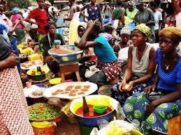 A photorealistic image of a bustling marketplace or business district where people from diverse backgrounds are actively engaged in economic activities. Showcase entrepreneurs of different ethnicities successfully running businesses, interacting with customers, and collaborating. The scene should be vibrant, dynamic, and portray a sense of inclusivity and shared economic prosperity. The image should be sharp and focused, with clear details of the diverse individuals and their businesses.