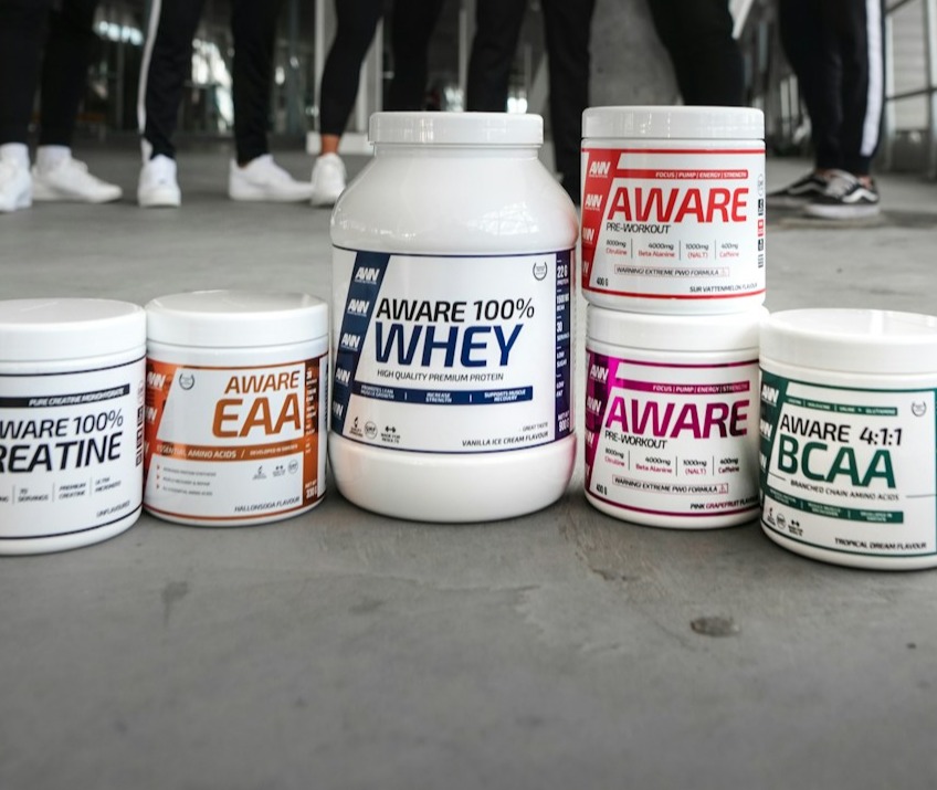 A practical image depicting an athlete choosing between whey and casein protein before training. The setting is a prep station with both protein types visibly displayed. The lighting should evoke urgency and focus, appealing to fitness enthusiasts. The camera angle captures the decision-making moment, emphasizing the user's engagement with their nutrition. Technical specs: 4K resolution, high quality.