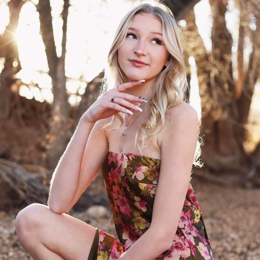 A stylish male and female model posing in a vibrant urban setting, with a creative street art backdrop. The lighting is dramatic, emphasizing their outfits and expressions, capturing the essence of modern fashion photography.