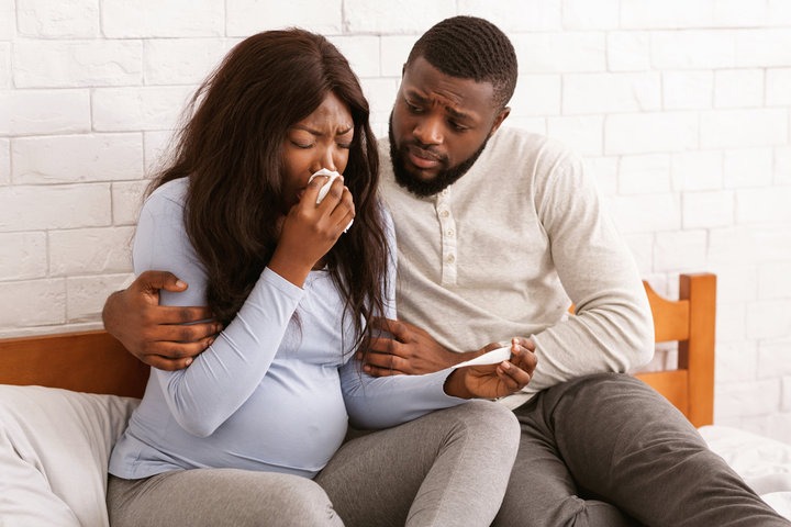 A photorealistic close-up of a doula holding the hand of a laboring woman, offering words of encouragement. Soft lighting, focusing on the connection and support. 4k resolution.
