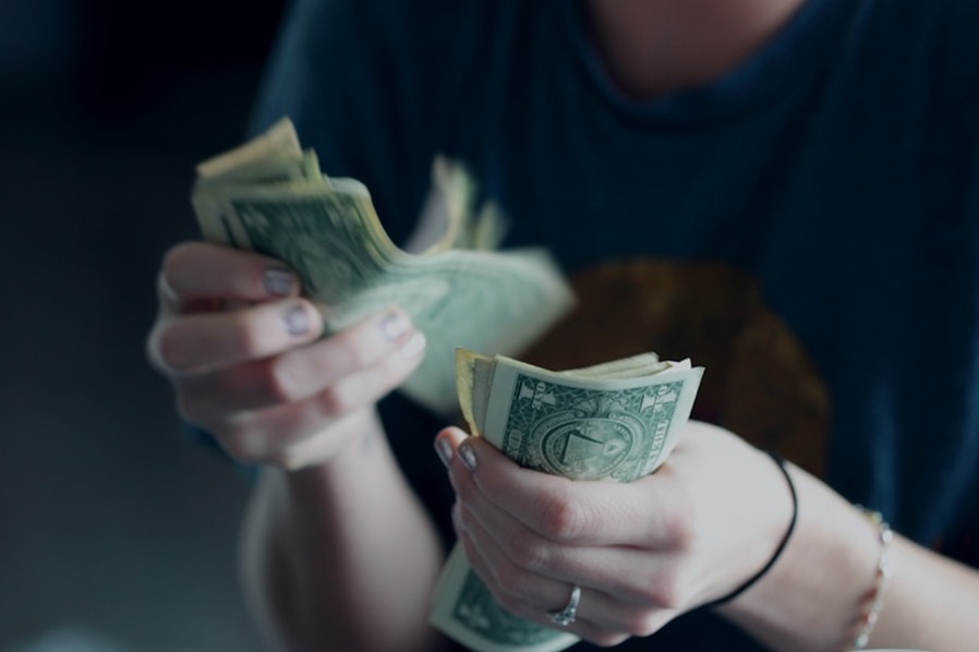 A team of professionals collaborating on a marketing strategy board, representing a diverse group of people. The board displays different elements like website design, social media marketing, video content, and analytics, showcasing the synergy between different marketing channels. The background features a bright and modern office space with a whiteboard and graphs, emphasizing the data-driven approach and strategic planning involved in marketing.