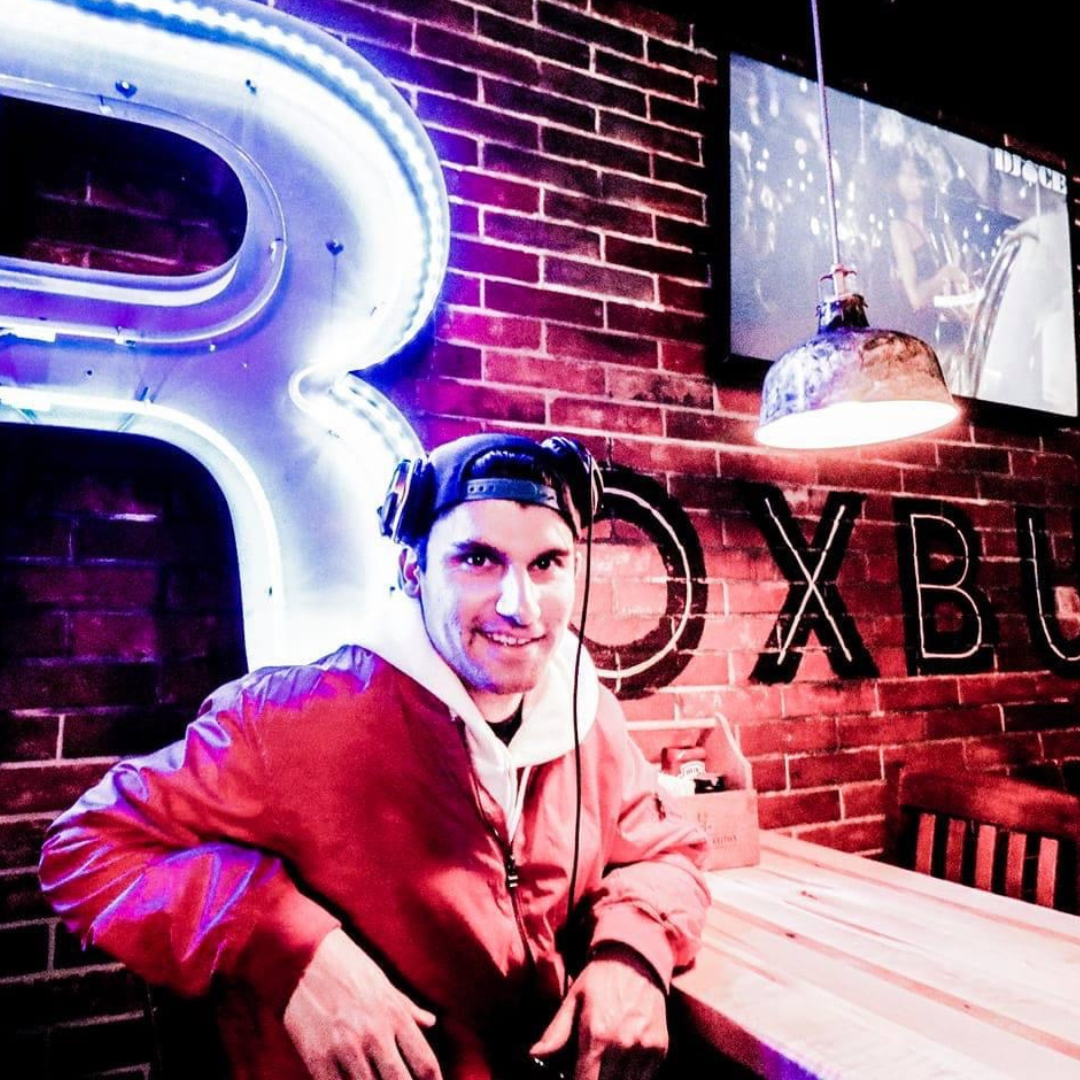 A photorealistic image of a lively private party with DJ Ace performing in a more intimate setting. The lighting is warm and inviting, creating a relaxed and fun atmosphere. The focus is on the guests, who are dancing, laughing, and enjoying each other's company. The overall style is casual and fun, reflecting the relaxed and personalized nature of a private party.