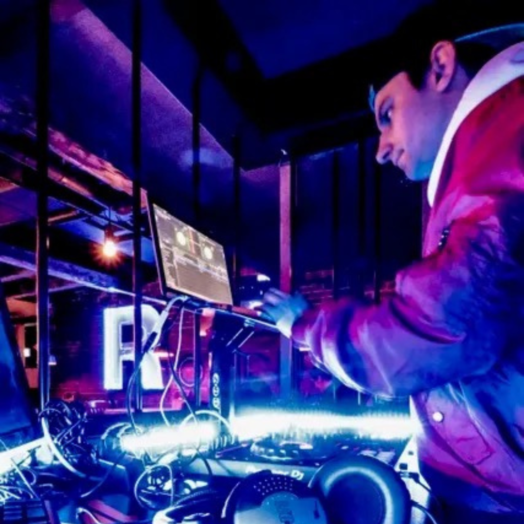 A photorealistic image of a modern and stylish corporate event with DJ Ace performing on stage. The lighting is dynamic and professional, creating an energetic and engaging atmosphere. The focus is on the attendees, who are enjoying the music and networking. The overall style is sleek and sophisticated, reflecting the professionalism and success of the company.
