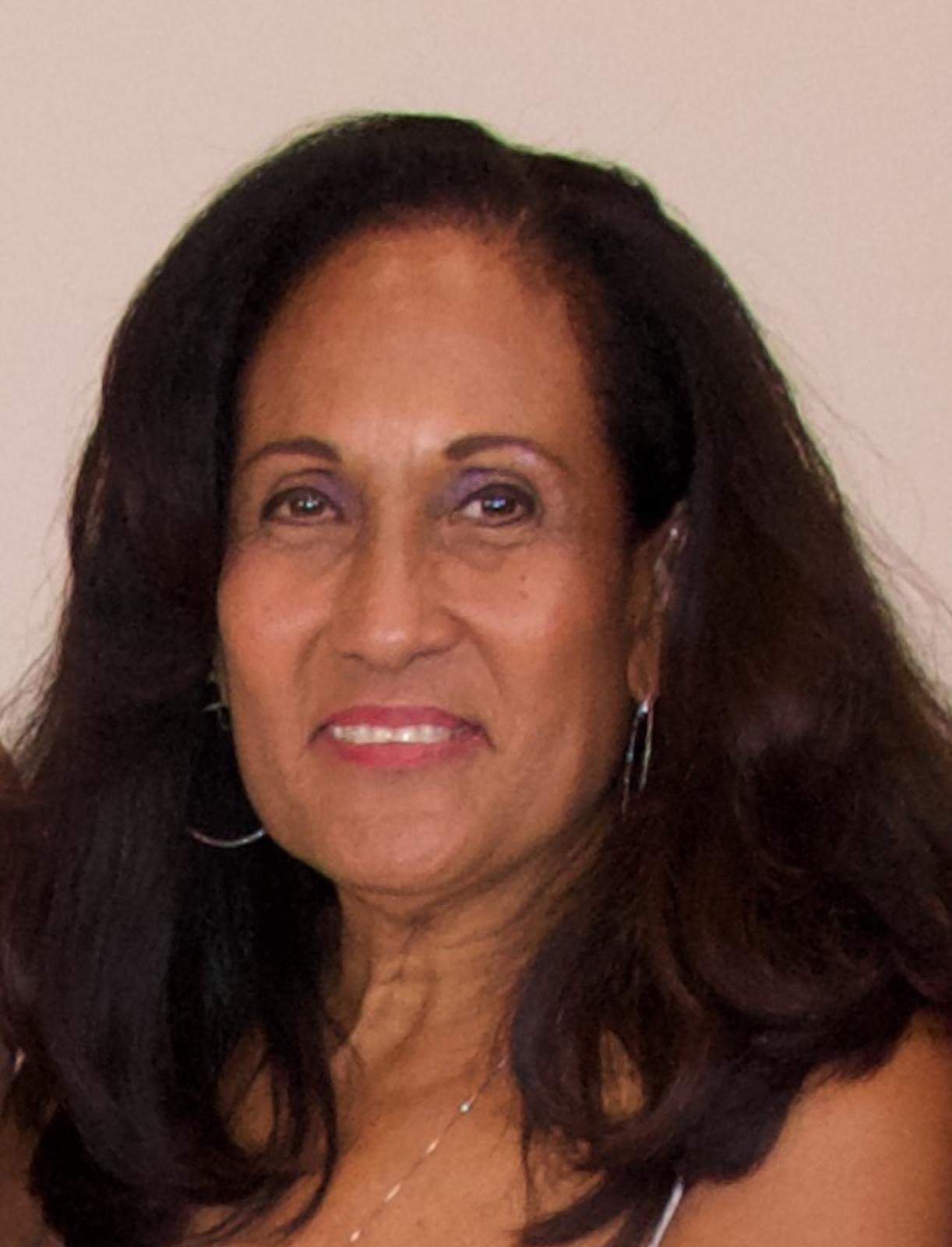 An image of a professional setting, showcasing Carole Ann Creque carefully handling official documents for a loan signing, emphasizing attention to detail and professionalism.