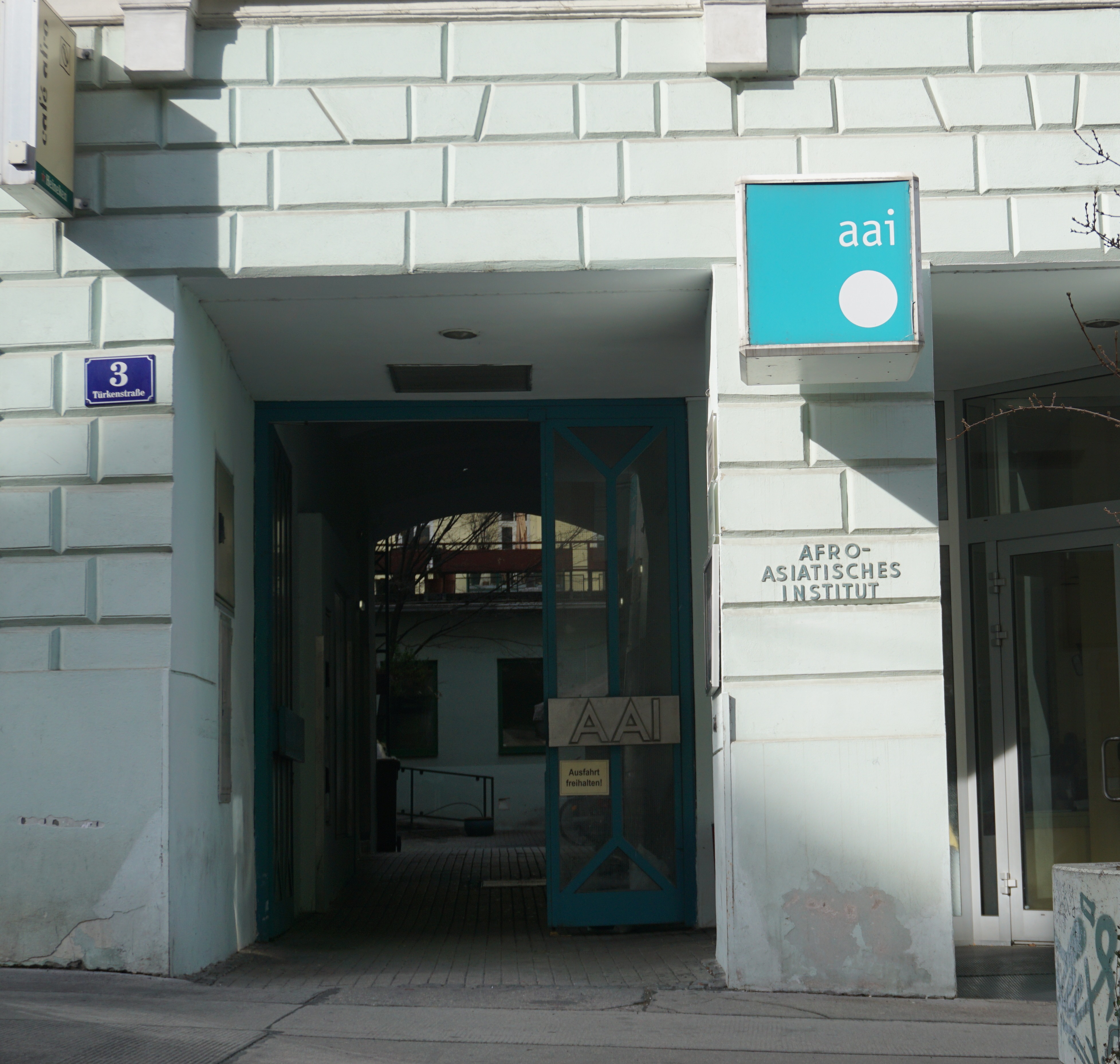 A photorealistic image of a modern, welcoming church building in Austria, with African architectural influences subtly incorporated into the design.  The building should be clean, well-maintained, and situated in a pleasant, residential or suburban neighborhood.  Include lush green landscaping and clear blue sky.  The image should evoke a sense of peace and community.