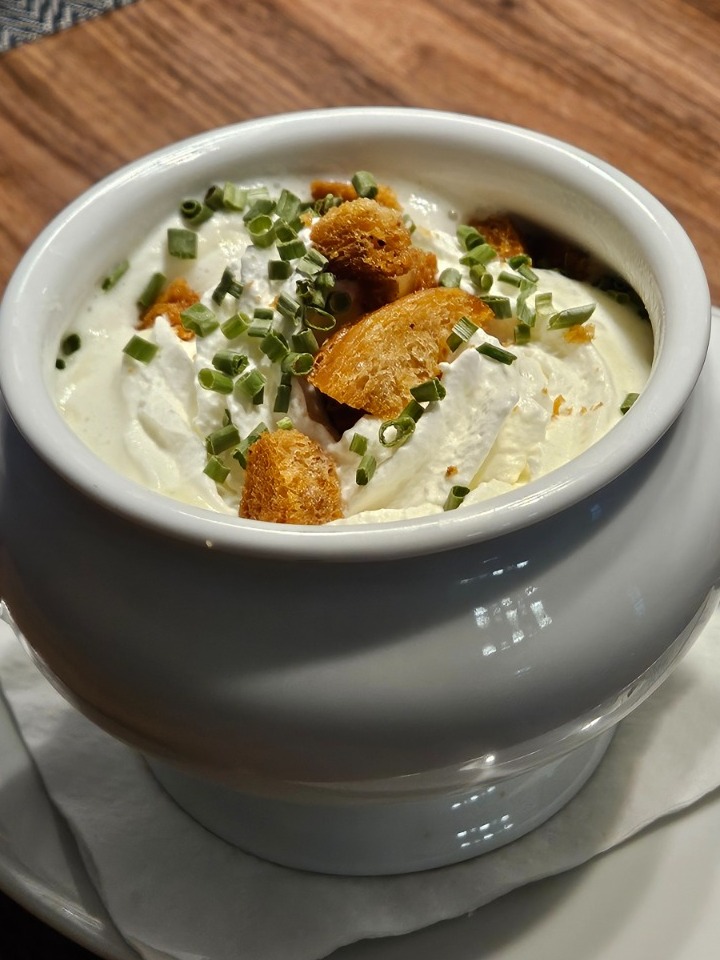 A shot of a chef tasting a sauce or dish, showing their dedication to quality and flavor. The expression on their face should convey passion and satisfaction.