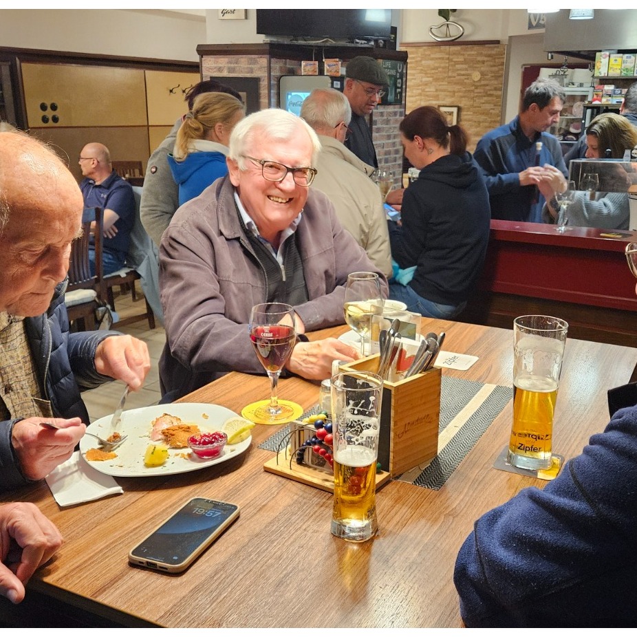 A beautifully plated dish being served by a friendly waiter in a warmly lit restaurant setting. The image should convey a sense of culinary excellence and attentive service.