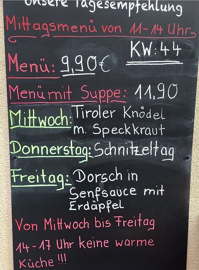 Stylized image of a chef's hands artfully plating a dish from the weekly menu. The image should convey a sense of artistry and attention to detail.