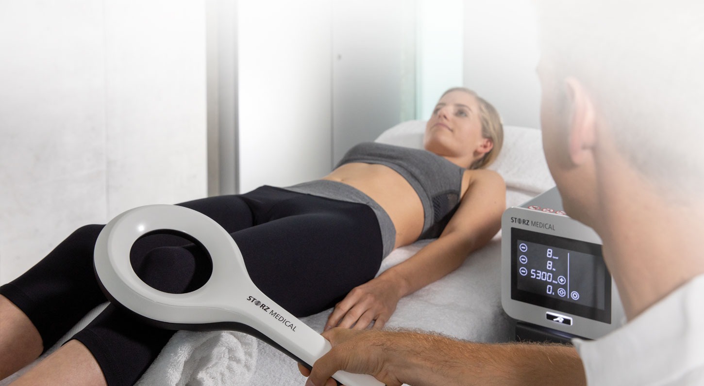 Design a photorealistic image illustrating the essence of 'Magnetic energy and how it can promote healing and reduce pain'. The focus should be on a serene therapy room with a person receiving magnetic therapy, surrounded by calming colors like lavender and soft blue. The lighting should be warm and inviting, with gentle shadows enhancing the peaceful atmosphere. Incorporate relevant props like magnetic devices and healing crystals. The camera angle should be eye-level, making the viewer feel a part of the experience. Use a clean and comforting composition. Ensure high quality and 4K resolution for clarity.