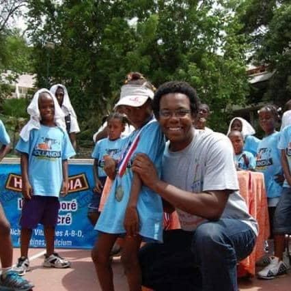 Create a photorealistic image showing medical professionals providing care in Benin. Show a clinic or outdoor medical outreach program, focusing on empathy, care, and healing. Use a calming color palette. The lighting should be soft and diffused. Capture details of medical equipment and medical staff interacting with patients with respect. The style should evoke a sense of trust and compassion.