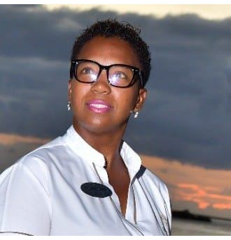 A captivating image that embodies the essence of Life Garden Spa & Healing. The scene features a serene outdoor spa garden surrounded by vibrant greenery and colorful flowers. In the foreground, a therapist is preparing a herbal massage, arranging fresh herbs on a wooden tray. Sunlight filters through the leaves, casting soft shadows and a warm glow over the setting. The color palette is rich in greens, soft pastels, and natural wood textures. Relevant props like essential oils and handwoven baskets add to the holistic atmosphere. Style references include nature-inspired wellness themes. Technical specs: 4K resolution, high quality.