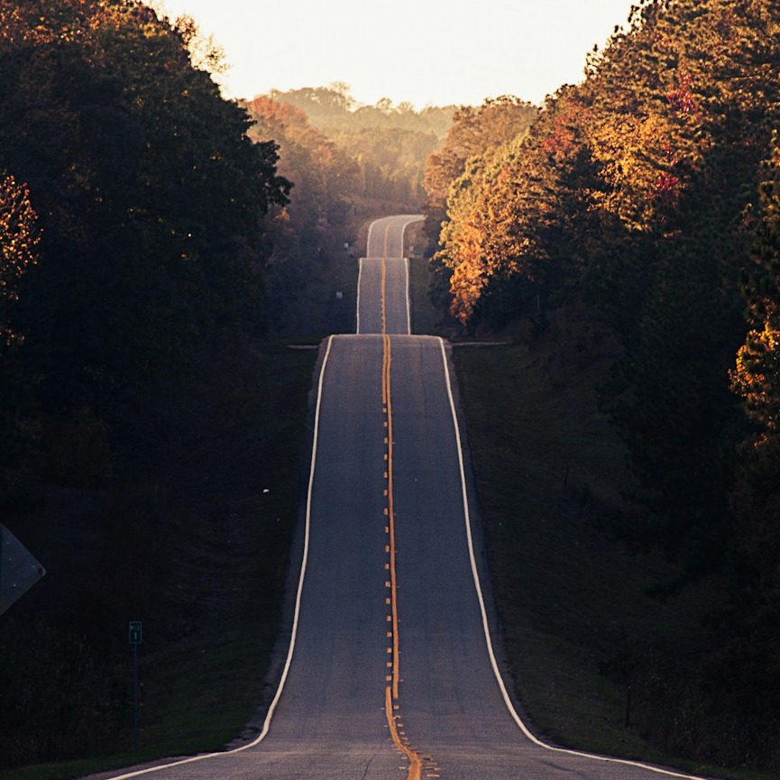 A diverse community health fair in a bright community center with various activity stations. People of all ages participate in group exercises, nutrition demonstrations, and health screenings while interacting warmly. Healthcare professionals move through the crowd offering guidance, with educational displays about preventive care. The scene should burst with social energy and color, capturing spontaneous interactions and learning moments. Overhead banners promote wellness themes while natural light floods the space from large windows. The composition should emphasize human connection and shared purpose through dynamic grouping, authentic expressions, and the integration of healthcare into community life.