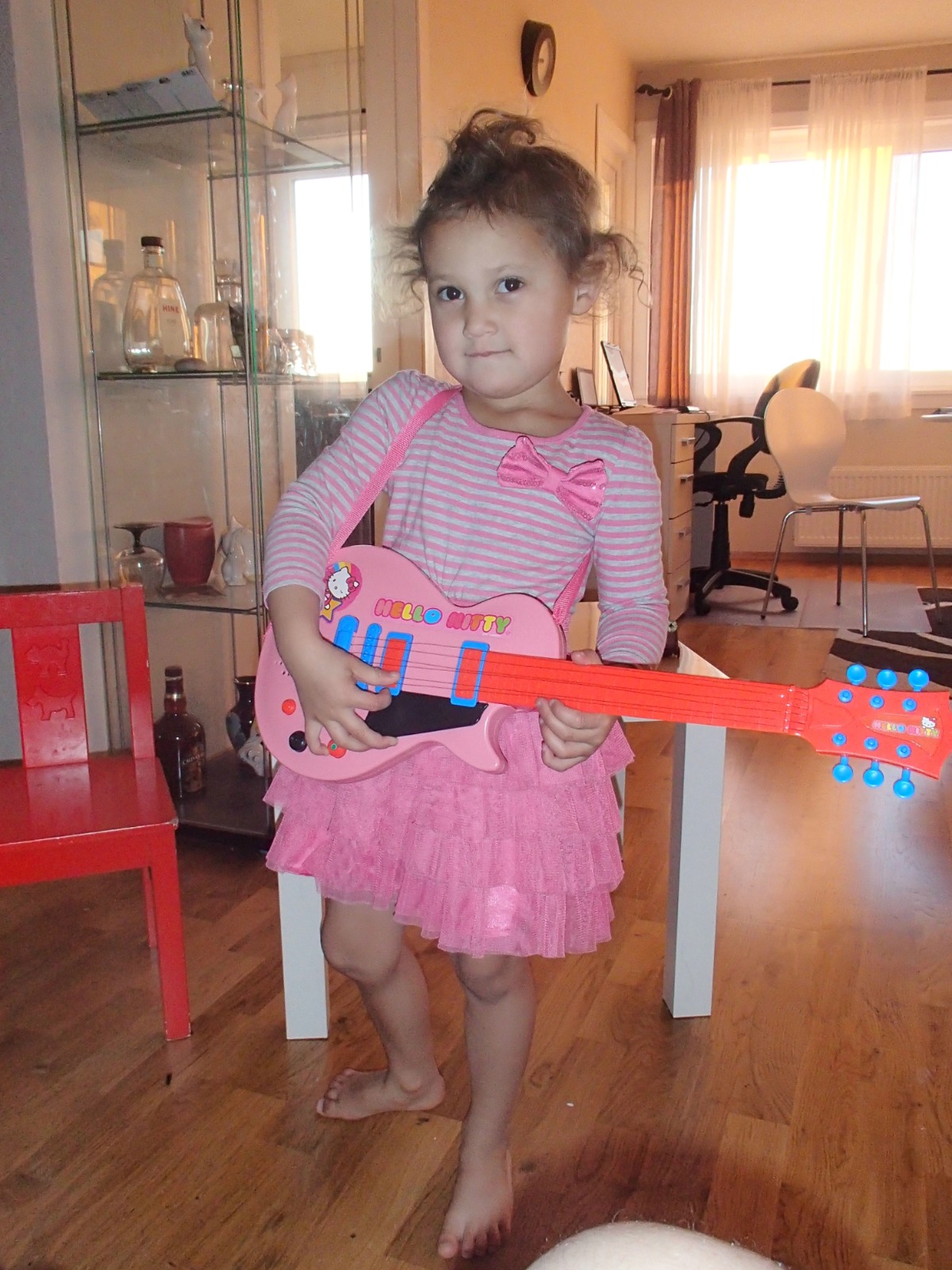 Design a visually appealing representation of 'The Soundtrack of My Life' for Ester Elin Lima Amdal. Imagine a stylized vinyl record with the album cover displaying a collage of images that represent her favorite artists, musical genres, and personal experiences associated with music. The background could feature musical notes, sound waves, and abstract patterns that evoke the feeling of music. Use a vibrant and dynamic color palette to reflect the energy and emotion of her favorite songs. The overall composition should feel nostalgic and personal, inviting viewers to explore her musical tastes.