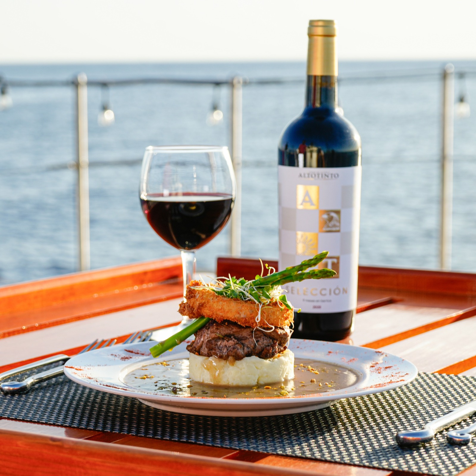 A stylized image that represents various culinary concepts served on the yacht, such as a mix of different dishes represented in an artistic way. Use vivid colors to entice the viewer.