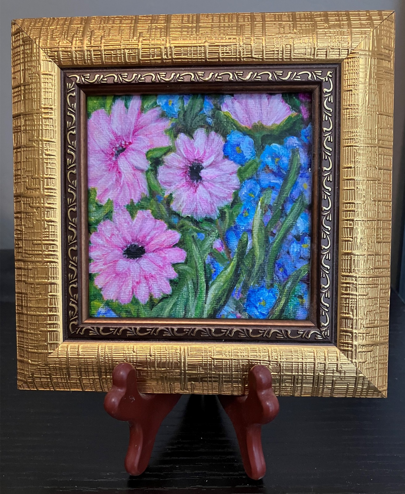 A photorealistic image of an abstract acrylic painting that utilizes drips, splatters, and layered textures. The colors should be a mix of soft, earthy tones with bright pops of color, showing the beauty that can be found even in seemingly chaotic expressions. The overall mood should be one of peace and serenity, highlighting the appreciation for the imperfect, natural beauty of the artwork.