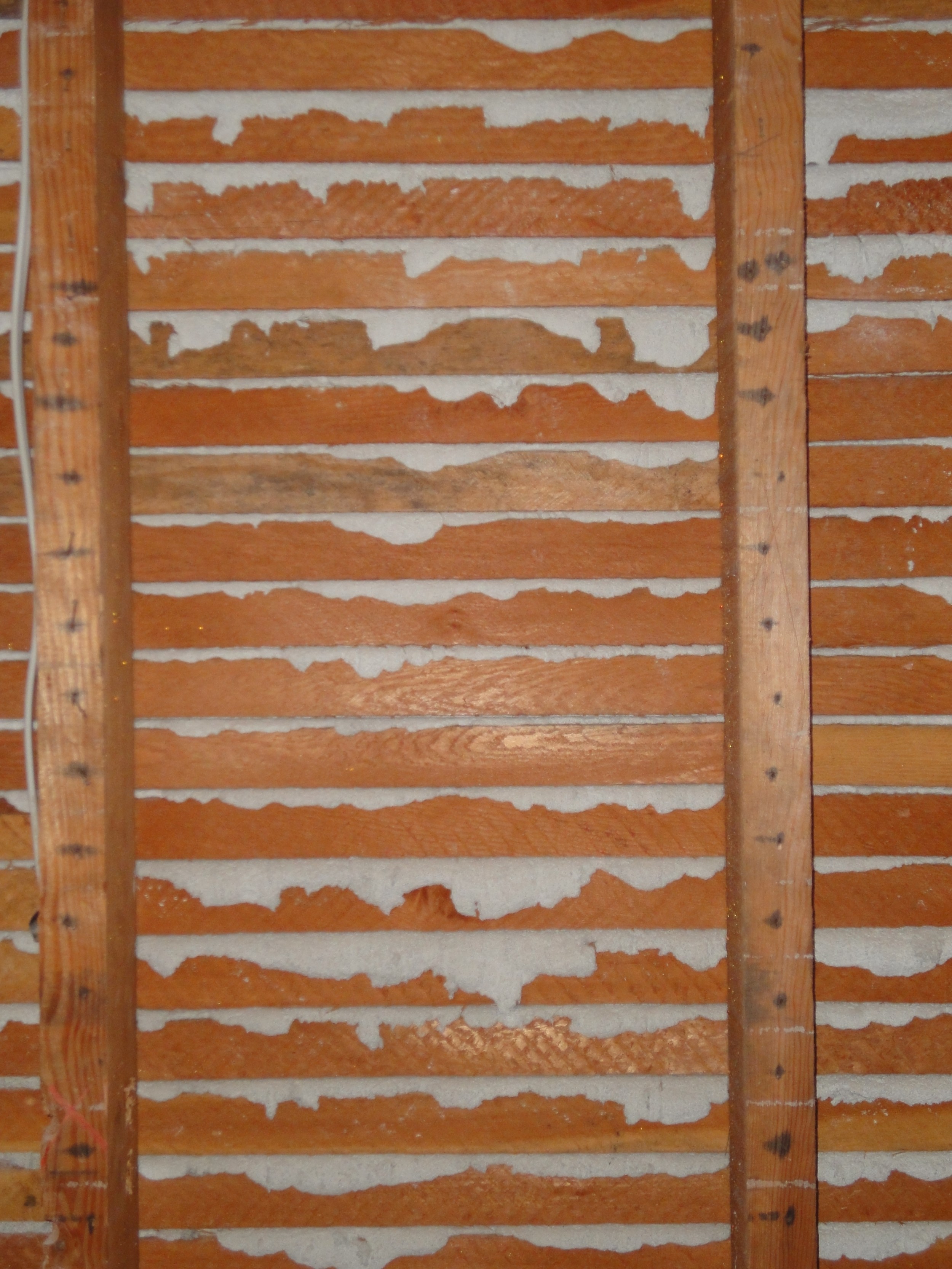Wood lath and plaster squeezing through the lath, causing a key