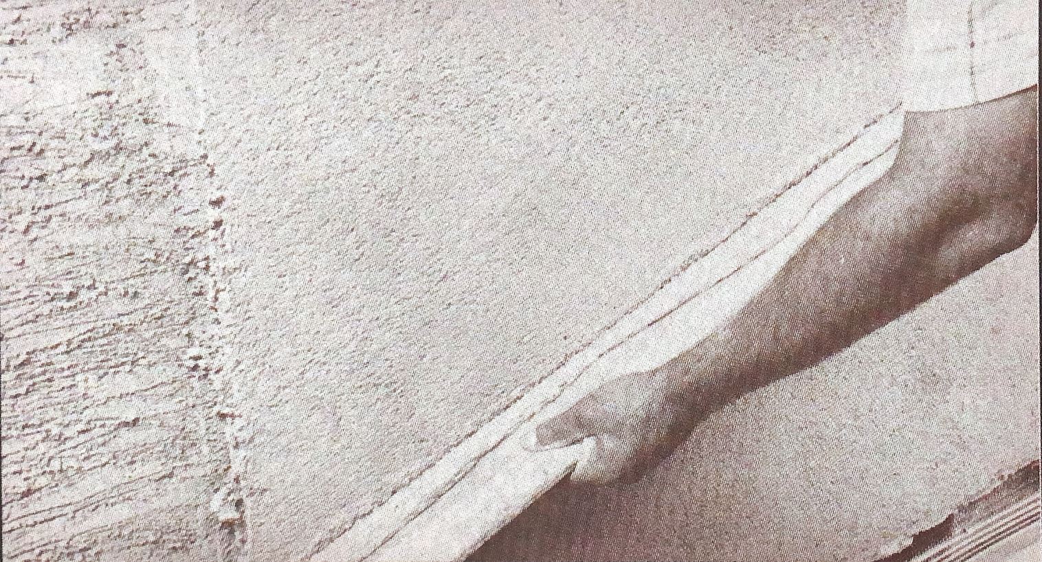 Darbying the brown coat to render a plumb and even surface