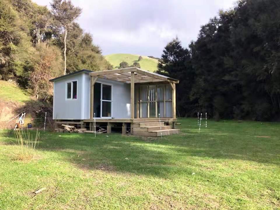 A vibrant, photorealistic image showcasing a community event at a cabin resort, featuring people of all ages engaging with nature activities like tree planting and workshops. The lighting is bright, giving an uplifting feel to the scene filled with greenery. The color palette includes lively greens, yellows, and earthy tones, celebrating community spirit and collective action towards sustainability. Resolution: 4K, high quality.