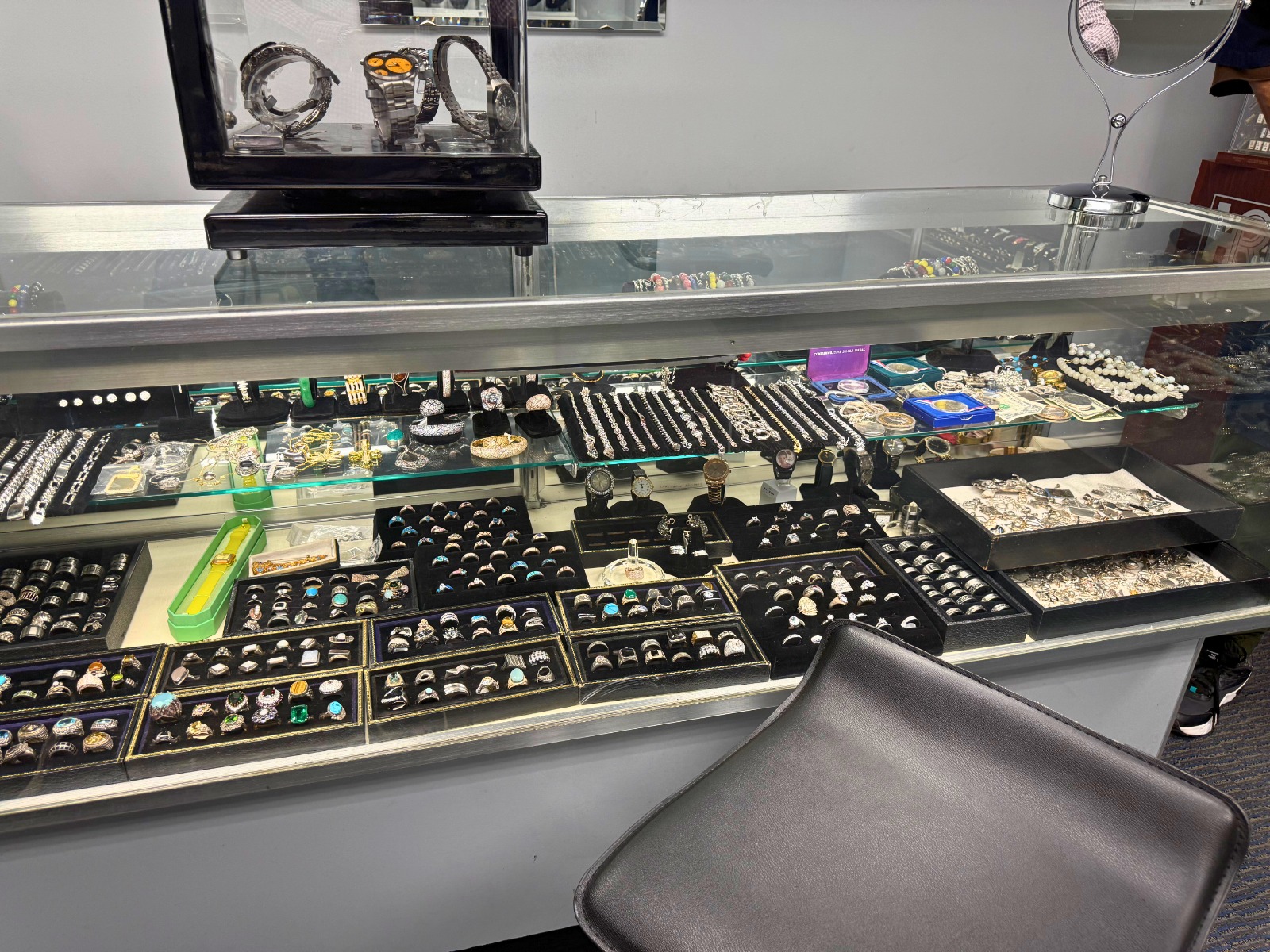 A close-up image of a skilled jeweler carefully soldering a ring. Focus on the intricate details of the repair process and the specialized tools being used. The lighting should be bright and focused on the work area.