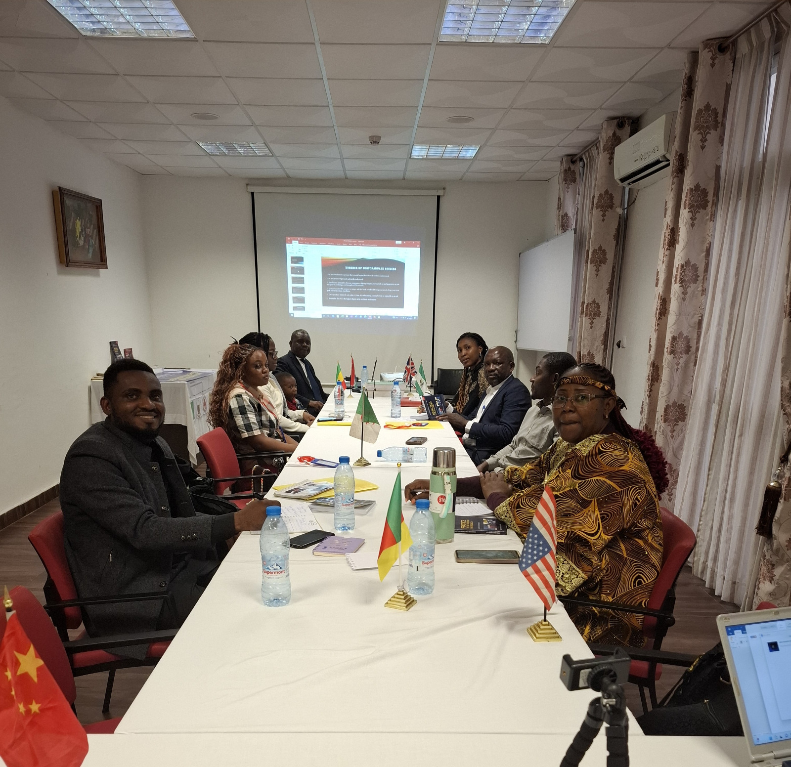 Visualize a team of consultants collaborating on a research project, reviewing data and providing feedback. The setting should be a modern and collaborative office space. Style: Collaborative, analytical, and supportive. Color palette: Professional and encouraging, with a focus on grays and blues.