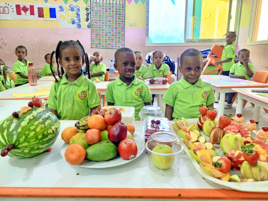 A group of kindergarten children are playing with colorful building blocks in a bright, sunlit classroom. The teacher is interacting with them, fostering creativity and collaboration. Soft, diffused lighting, pastel colors, focus on happy, engaged faces. Technical specs: 4K resolution, photorealistic.
