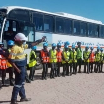 Create a photorealistic image of a group of people kayaking down a river through a lush forest. The sun should be shining, and the kayakers should be smiling and enjoying the adventure. The scene should convey a sense of excitement and natural beauty.