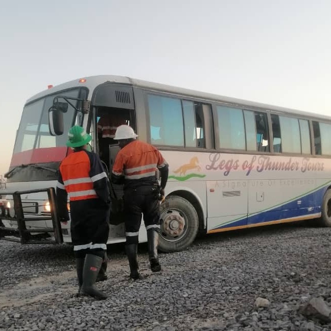 Create a photorealistic image of a travel agent assisting a client in creating a custom travel itinerary. The agent and client should be looking at a map with potential destinations highlighted. The scene should evoke collaboration and excitement for planning a unique trip.