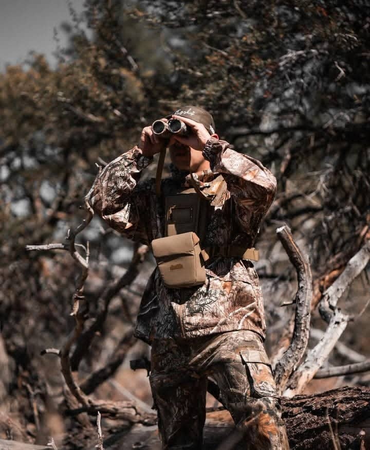 A photorealistic image of a hunter carefully examining animal tracks in the sand. Focus on his respect for the animal and his commitment to ethical hunting practices. Soft, natural lighting and a shallow depth of field. 4K resolution, high detail.
