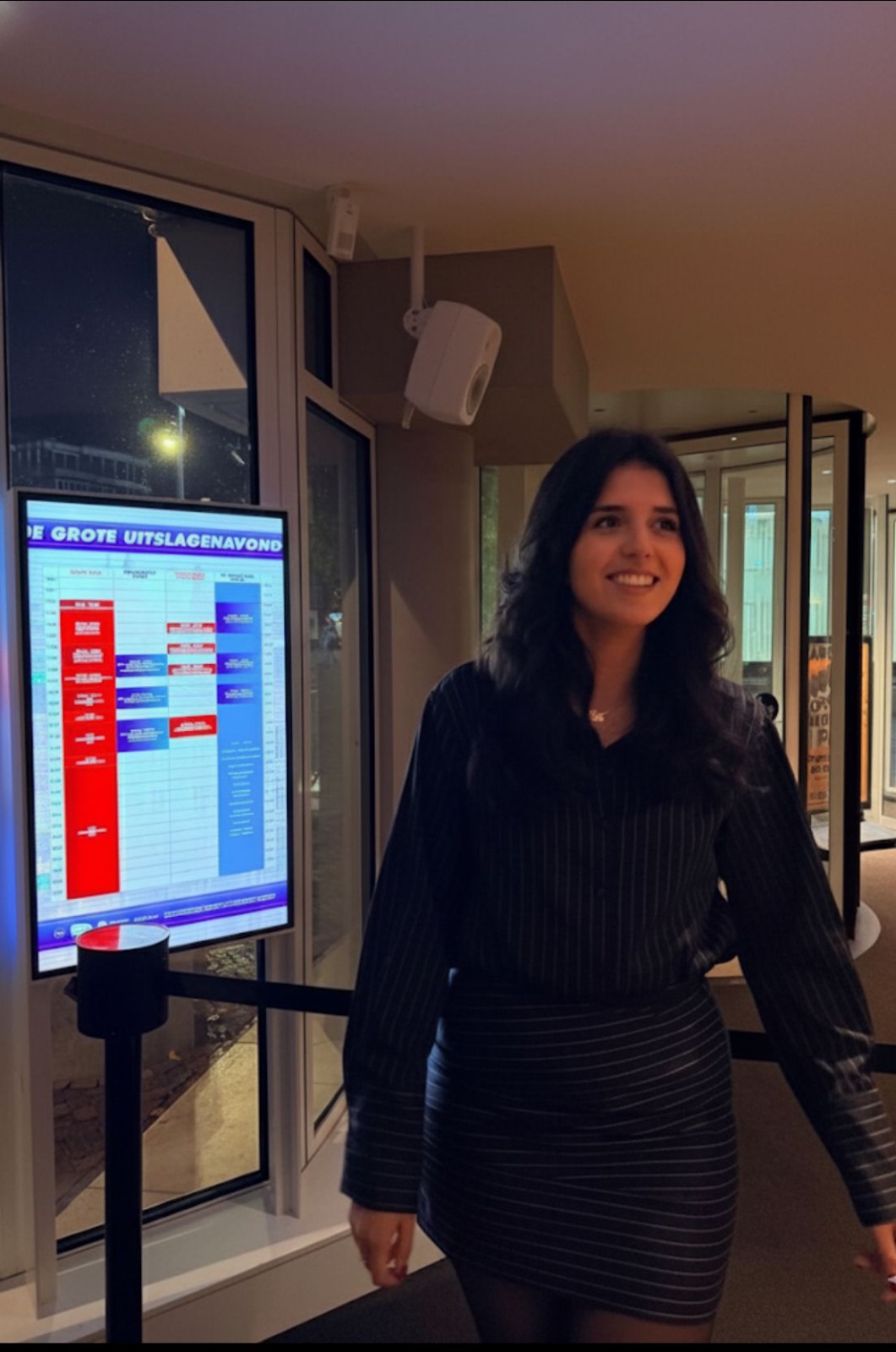 Create an image of a consultant working with a team of young people around a table, reviewing documents and discussing strategies. Show them collaborating on a project, with the consultant providing guidance and expertise. The atmosphere should be professional, collaborative, and results-oriented. Use warm, inviting lighting and a balanced composition to convey trust and partnership. Style: Corporate collaboration photography. Technical Specs: 4K resolution, high quality, photorealistic.