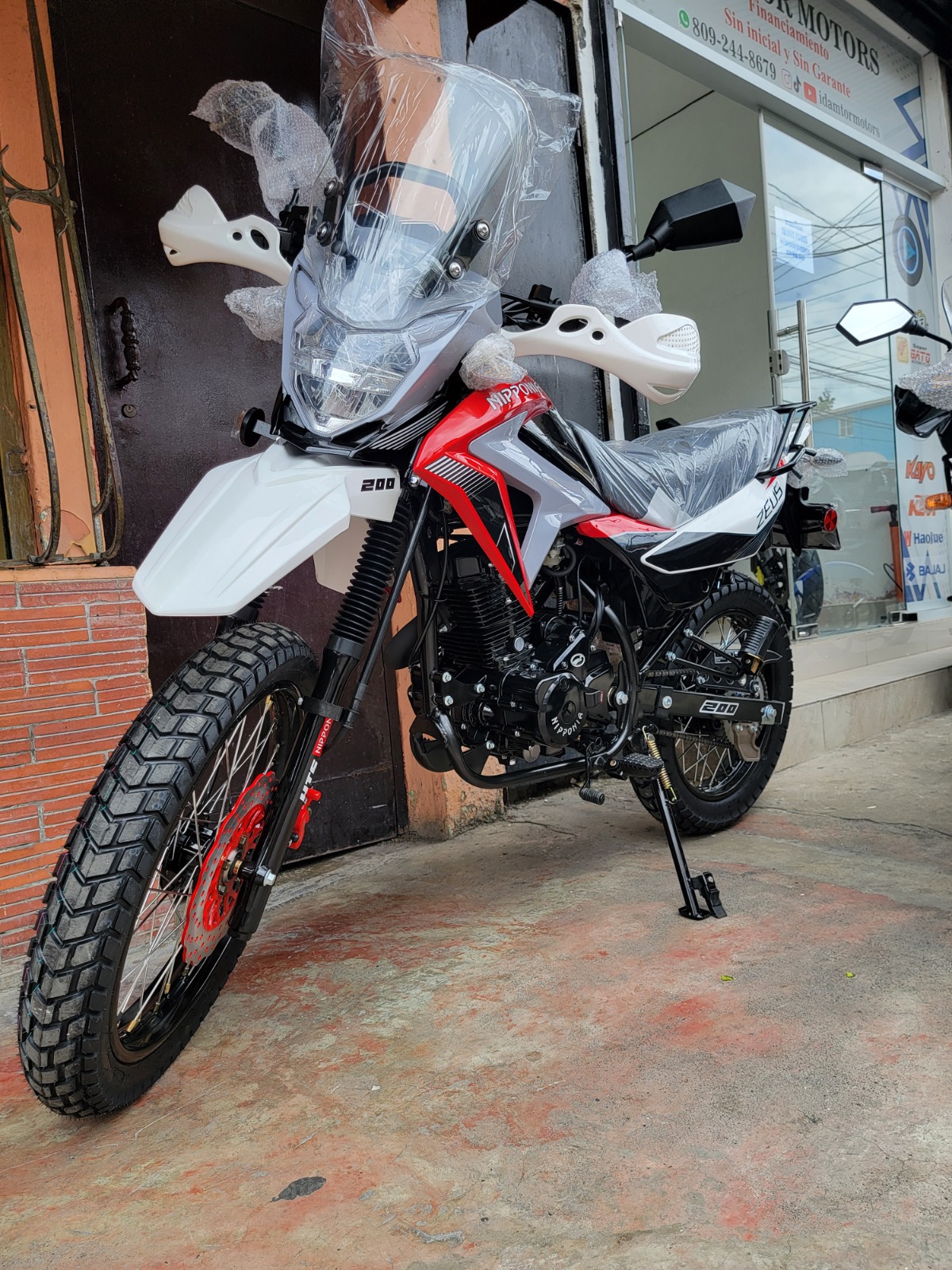 Visualize a group of diverse professionals pointing towards a motorcycle on a screen, indicating expert advice and guidance. Use bright, professional lighting.