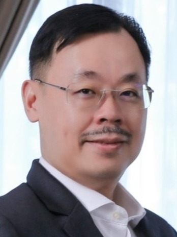 A photorealistic image of a panel discussion featuring three Feng Shui experts. They are seated at a table, engaging with the audience. The backdrop displays the East Chen Consultancy logo subtly. The lighting is professional, ensuring each expert is clearly visible. The composition should capture their expertise and approachability. The color palette is warm and inviting, emphasizing trust and knowledge. The resolution is 4K, ensuring sharp details and a professional aesthetic.