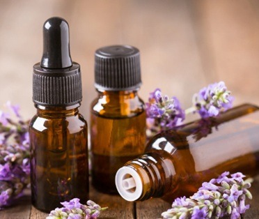  Several small bottles of essential oils arranged artfully on a wooden surface, with soft, diffused light highlighting their colors. A diffuser emits a gentle mist in the background. Focus on the vibrancy of the oils and the calming atmosphere. Color palette: Natural, muted colors with highlights on the oil's hues. Style: Serene, aromatic. 4K resolution.