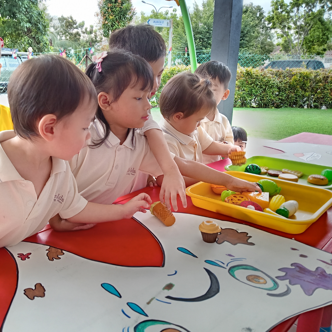Children participating in an art class, painting with vibrant colors. The lighting is bright and energetic. The camera angle is a wide shot, capturing the group activity and the colorful artwork. Style: Action.