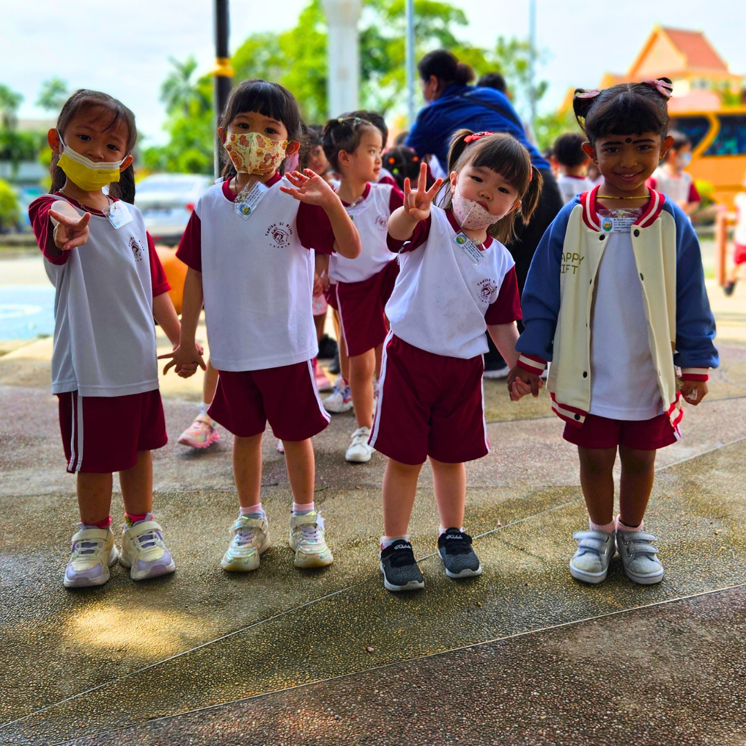 A 4K high-quality stylized image representing the mission of Si Bijak Preschool. The image portrays a stylized tree with vibrant, colorful leaves, each leaf representing a different aspect of a child's development: cognitive, social, emotional, and physical. At the base of the tree, stylized children are playing and interacting. The color palette is warm and inviting, featuring earthy tones and bright accents. The background is a soft, dreamy landscape with a clear blue sky. The camera angle is a wide shot, capturing the entire tree and its surroundings. Texture details are smooth and polished. The style is inspired by contemporary illustration, with a focus on simplicity and visual appeal. This image should convey the concept of growth, learning, and holistic development offered by Si Bijak.