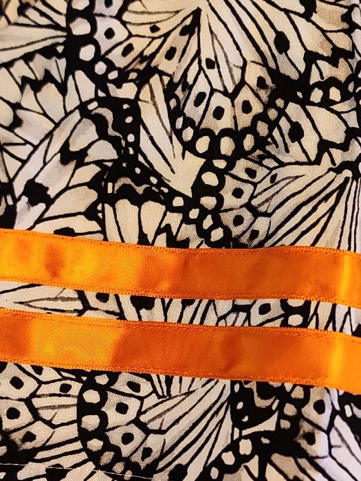 black butterfly with orange ribbons