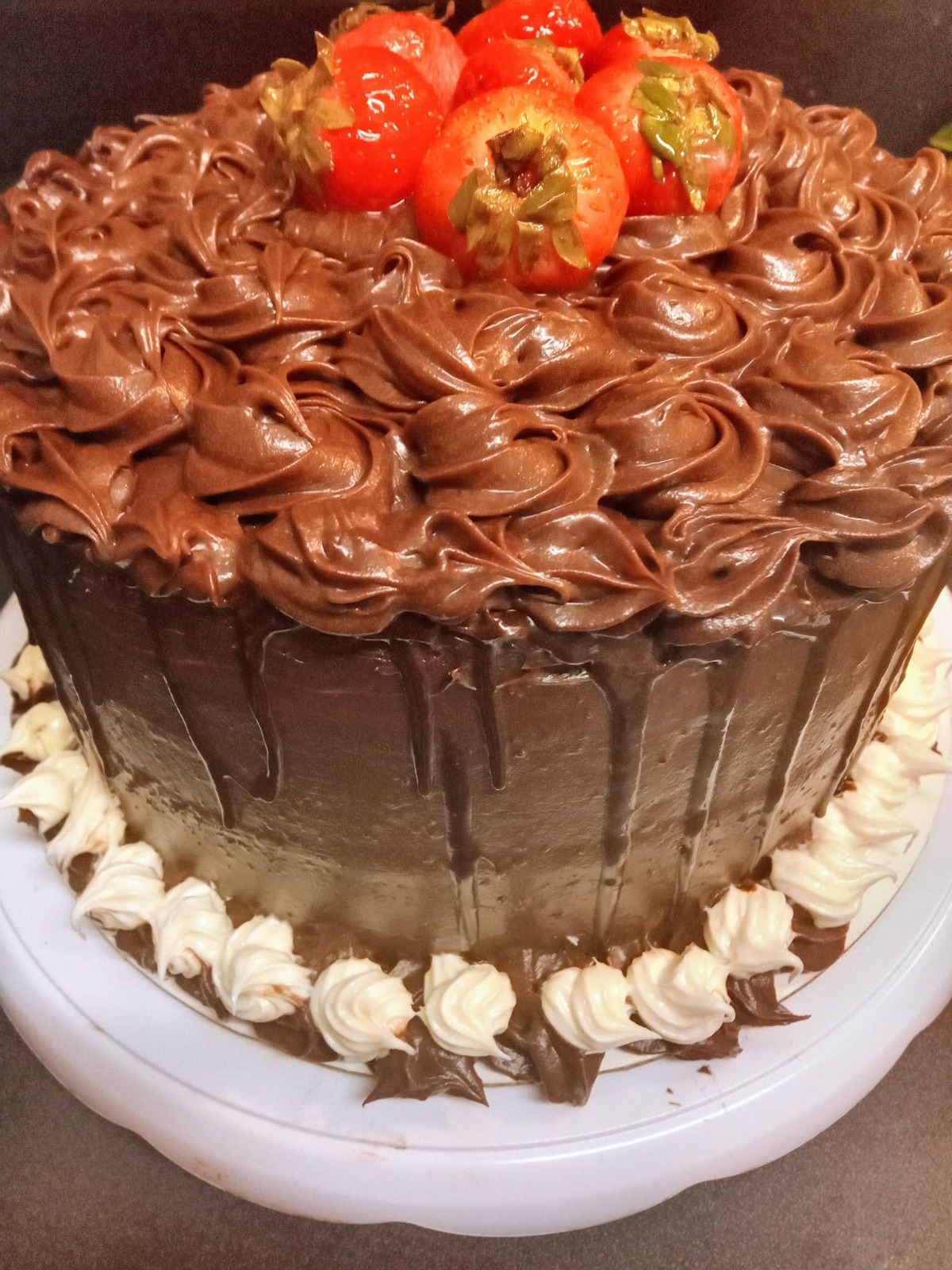 An appealing image of a beautifully decorated custom cake on display at an event. The cake stands majestically atop an elegant table with decorative elements surrounding it, such as fresh flowers and candles. The camera angle captures the intricate design and colors of the cake. The lighting is soft, drawing attention to the cake's details while providing a festive atmosphere. Style references: beautiful cake displays. Technical specs: 4K resolution, high quality.
