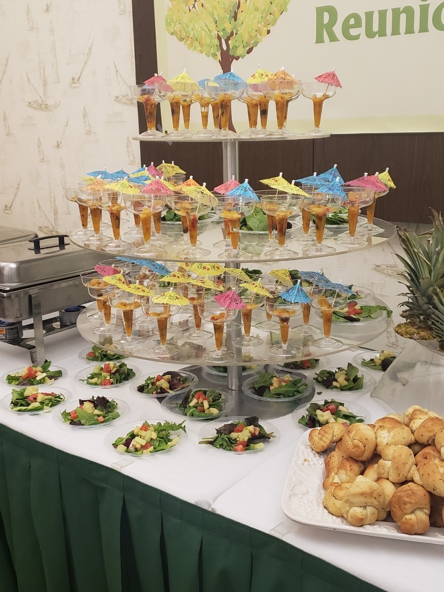 A professional setup for a corporate event, showcasing beautifully arranged catering options. The focus is on detail, with elegantly presented dishes designed to impress executives. The environment is sleek and modern, with soft tones and focused lighting highlighting the food. Style references: modern corporate setups. Technical specs: 4K resolution, high quality.