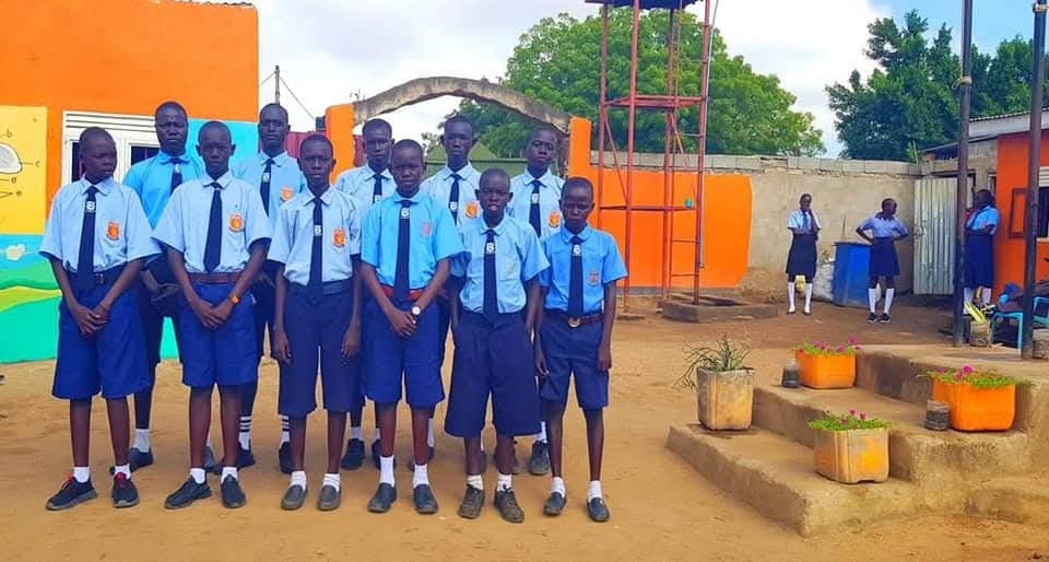 A focused image of secondary school students working collaboratively on a complex project in a modern classroom. The lighting is focused and professional. The camera should convey a sense of seriousness and academic rigor. 4k resolution, photorealistic.