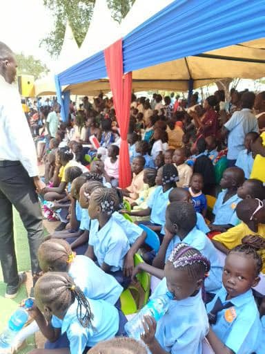 Primary school students engaged in a science experiment outdoors, observing plants and insects with magnifying glasses. Sunny and cheerful, 4k resolution, photorealistic.