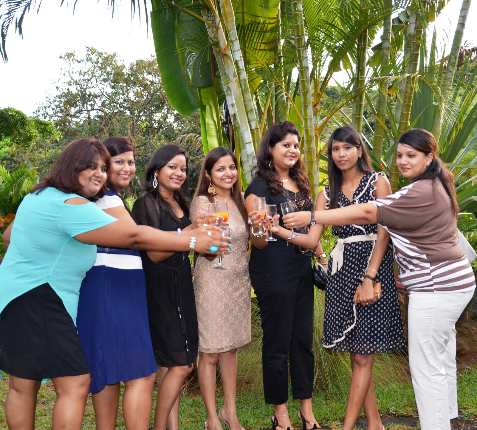 A photorealistic image depicting a diverse group of people – colleagues, friends, and families – gathered in a park for a summer picnic. The scene exudes joy, laughter, and togetherness. Some people are playing games, others are chatting and enjoying food, and children are running around freely. The background features lush greenery, trees, and a clear blue sky. The lighting is bright and natural, casting a warm and inviting glow over the scene. The color palette is vibrant and cheerful, with greens, blues, yellows, and reds predominating. The camera angle should be a medium shot, capturing the interactions and emotions of the people. Capture texture details such as the grass, the fabric of the picnic blankets, and the food. Style references: Norman Rockwell painting with a modern twist. Technical specs: 4K resolution, high quality.