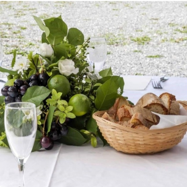 An artfully arranged buffet table laden with a variety of delicious dishes, showcasing the culinary expertise and attention to detail of our catering services. Warm, appetizing lighting. 4K resolution.