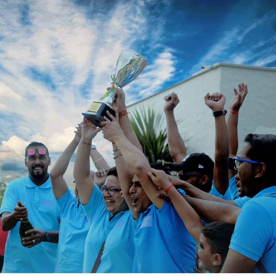 A group of smiling teammates are celebrating a victory. Capture their joy and excitement with a wide-angle shot and vibrant colors. Add confetti and other celebratory elements. Style: Candid photography, focus on authentic emotions.