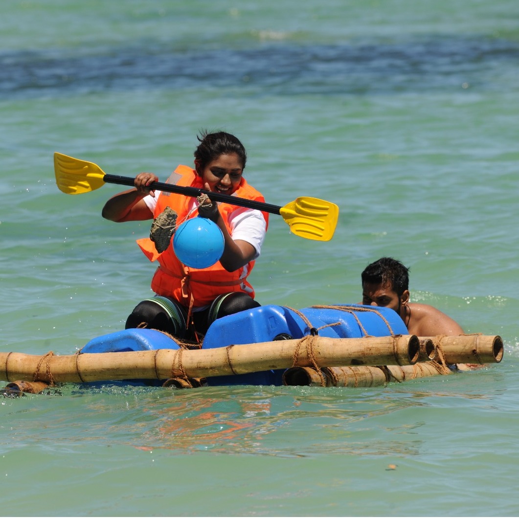 Create a photorealistic image of a team scaling a climbing wall. The wall should have varying levels of difficulty. Capture the determination on their faces and the support they give each other. Use dynamic lighting to emphasize their movement. Style: adventure photography, focus on energy and teamwork.