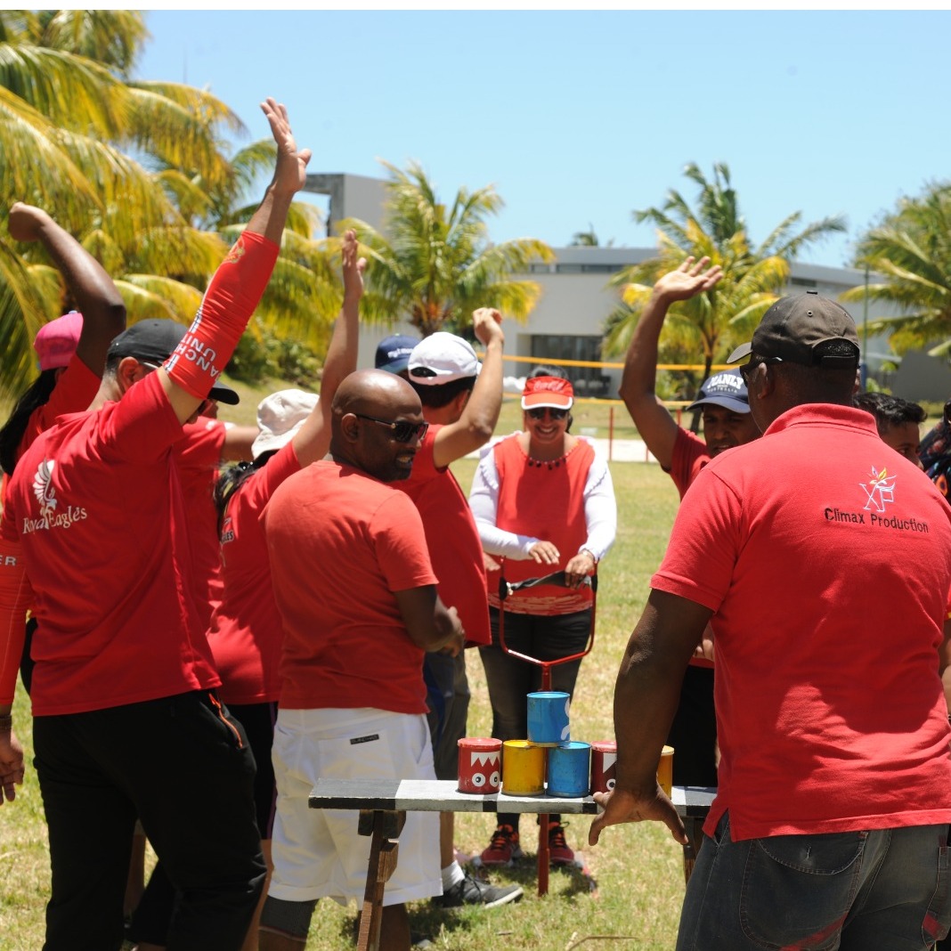 Imagine a team working together to solve a complex puzzle in a lush forest. Use vibrant colors and natural lighting to create a sense of adventure and discovery. Focus on the expressions of concentration and teamwork. Style: Environmental portraiture.