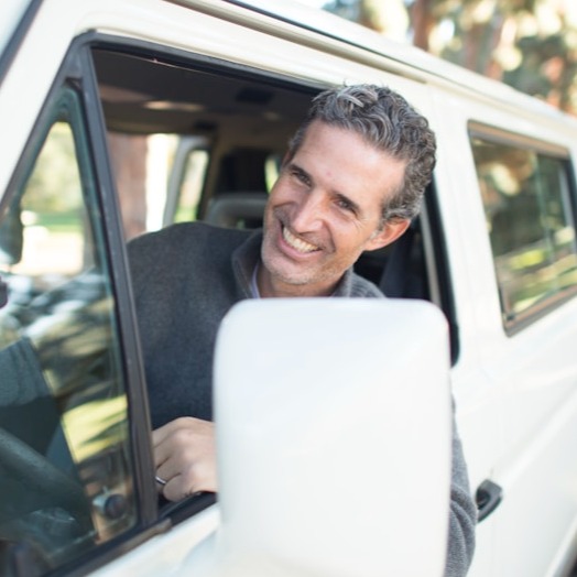 A stylized image showing a happy customer driving away in a sparkling clean car, with a dollar sign subtly integrated into the background. The customer is smiling and waving. Lighting: bright and cheerful. Color palette: vibrant and positive. Camera angle: medium shot conveying a sense of freedom and satisfaction. Style: modern, slightly cartoonish illustration.